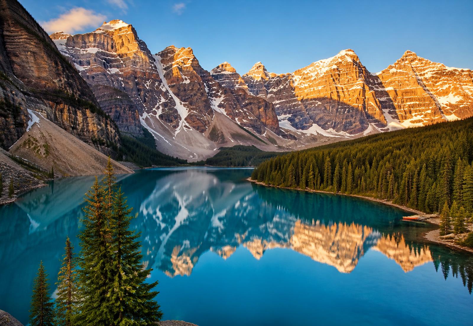 Turquoise Moraine Lake reflecting the Canadian Rockies at sunrise